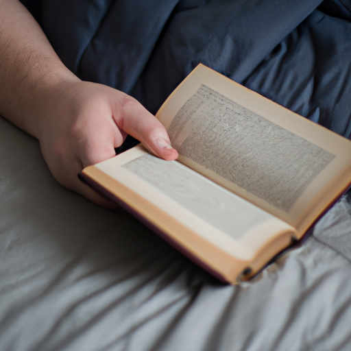 A person reading a book in bed as part of a relaxing bedtime routine.